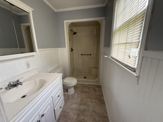  - bathroom with a shower stall, wainscoting, vanity, and crown molding