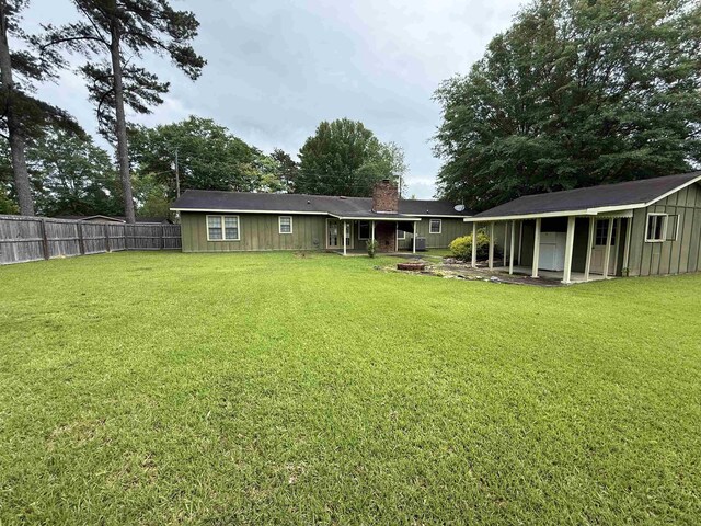  - rear view of property with a chimney and an outdoor structure