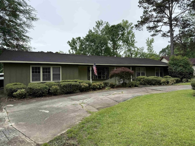  - single story home featuring board and batten siding and a front yard