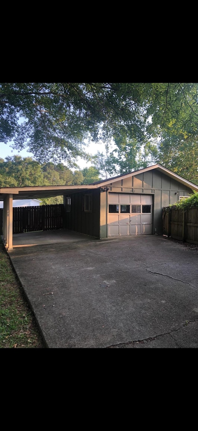  - garage featuring a carport and driveway