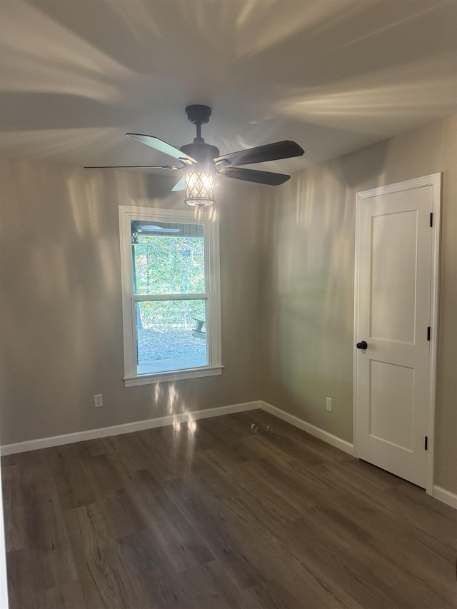 spare room with ceiling fan and dark hardwood / wood-style floors