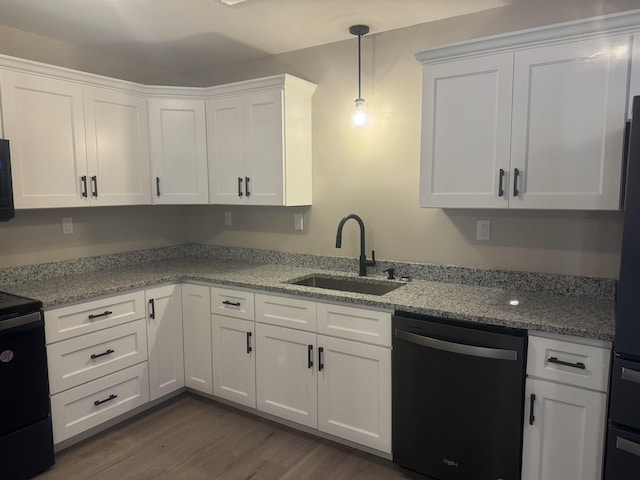 kitchen featuring light stone countertops, dark hardwood / wood-style flooring, sink, black appliances, and white cabinets