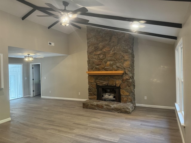 unfurnished living room with lofted ceiling with beams, ceiling fan, light wood-type flooring, and a fireplace