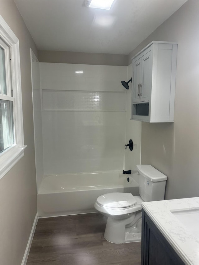 full bathroom with hardwood / wood-style floors, vanity, toilet, and bathtub / shower combination