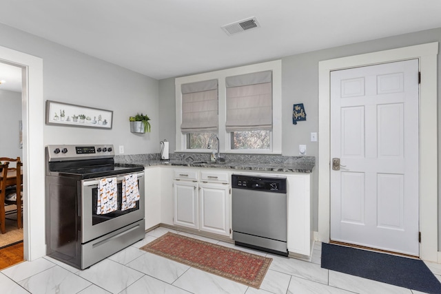 kitchen with white cabinets, sink, and appliances with stainless steel finishes