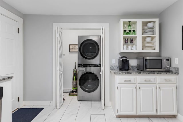 washroom with stacked washer / drying machine