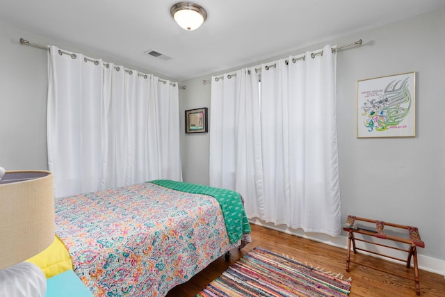 bedroom with hardwood / wood-style flooring