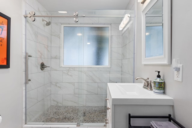 bathroom featuring vanity and a shower with shower door