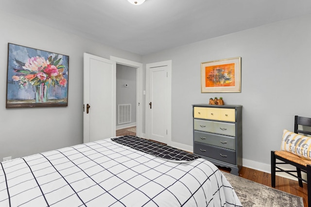 bedroom with dark hardwood / wood-style floors