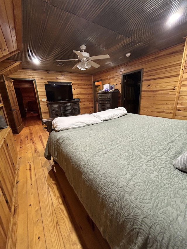 4940 Kent Rd, Tremont, MS 38876 - bedroom featuring ceiling fan, wood ceiling, wooden walls, and light hardwood / wood-style flooring