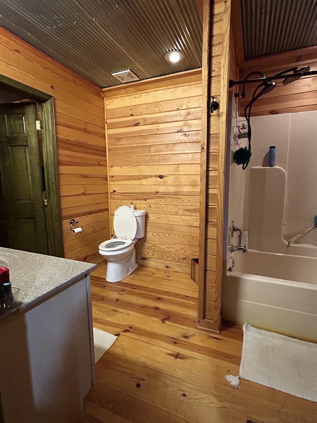 4940 Kent Rd, Tremont, MS 38876 - full bathroom with vanity, wooden walls, wooden ceiling, washtub / shower combination, and toilet
