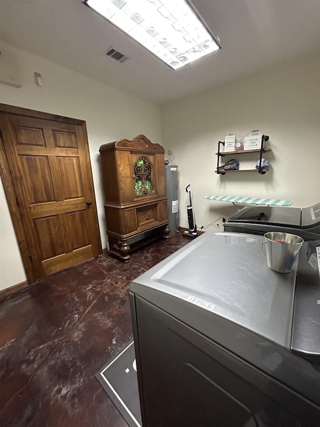 4940 Kent Rd, Tremont, MS 38876 - washroom featuring electric water heater and washing machine and dryer