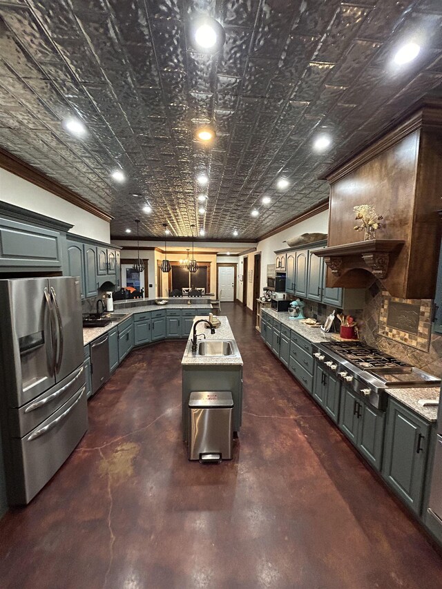 4940 Kent Rd, Tremont, MS 38876 - kitchen with appliances with stainless steel finishes, gray cabinetry, sink, decorative light fixtures, and a center island with sink
