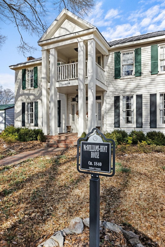 greek revival house featuring a balcony