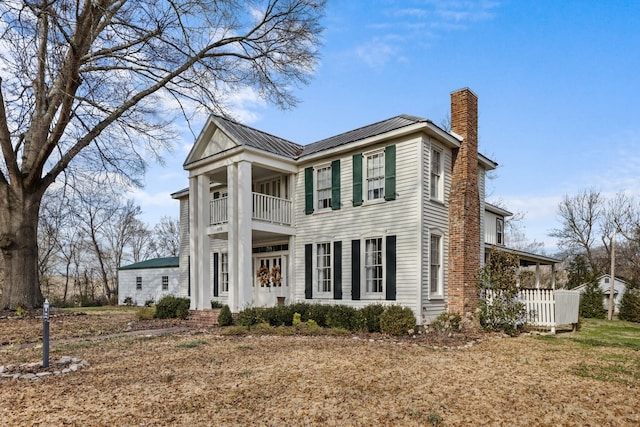 neoclassical home with a balcony