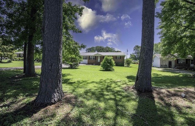  - view of front facade with a front lawn
