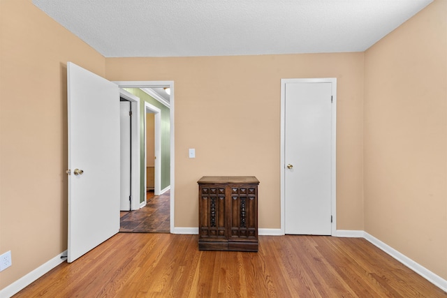  - spare room with wood finished floors and baseboards