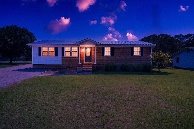 - single story home with a yard and metal roof