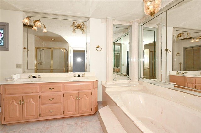 bathroom featuring tile patterned flooring, vanity, independent shower and bath, and decorative columns