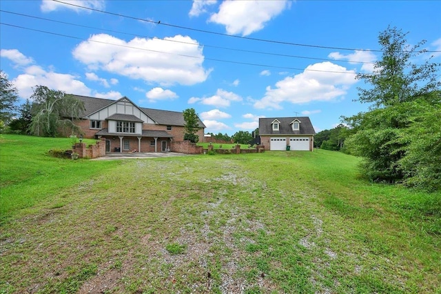 view of yard with covered porch and a garage