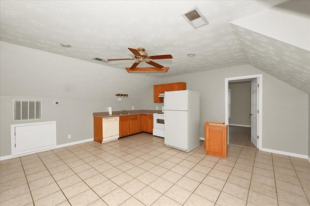 kitchen with a textured ceiling, white appliances, ceiling fan, sink, and lofted ceiling