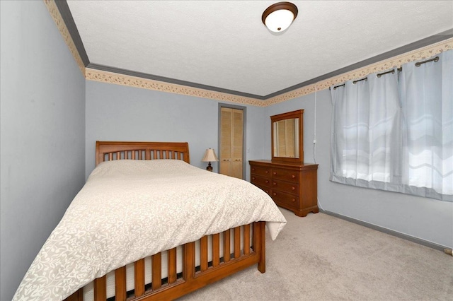 carpeted bedroom featuring a textured ceiling, a closet, and ornamental molding