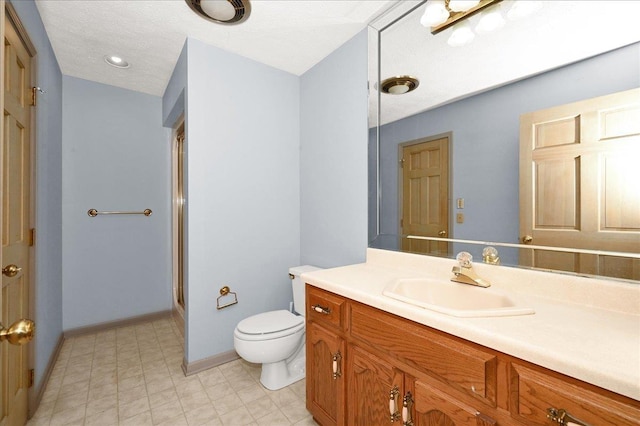 bathroom with vanity, toilet, and walk in shower