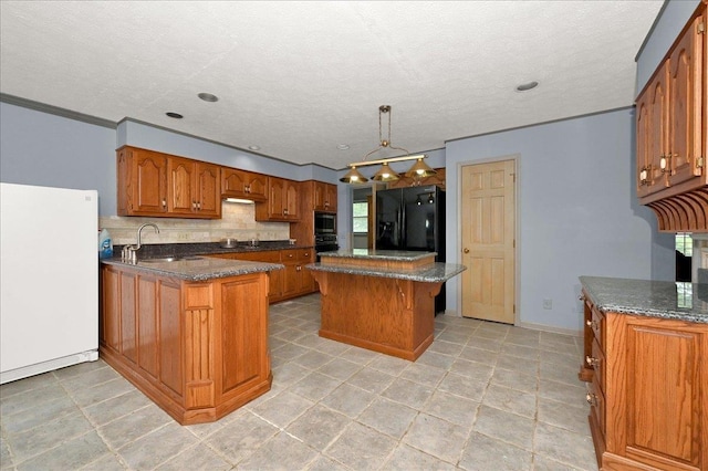 kitchen featuring decorative backsplash, sink, black appliances, decorative light fixtures, and a kitchen island