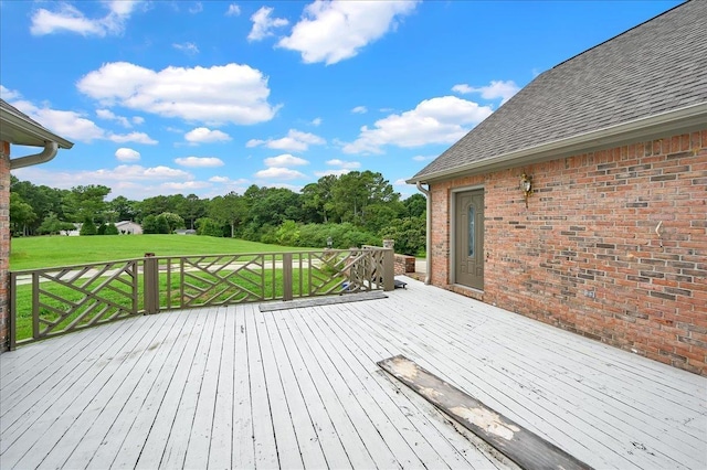 wooden deck featuring a yard