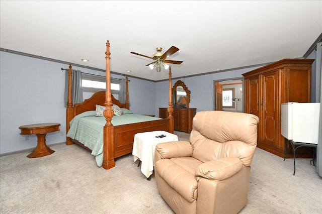 bedroom featuring ceiling fan, crown molding, and light colored carpet