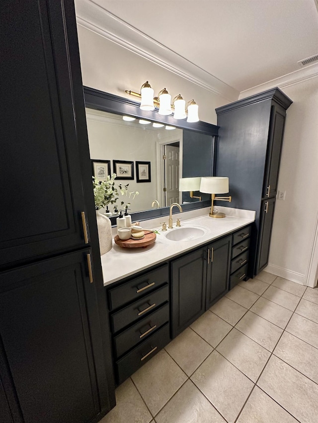 bathroom featuring tile patterned flooring, crown molding, and vanity