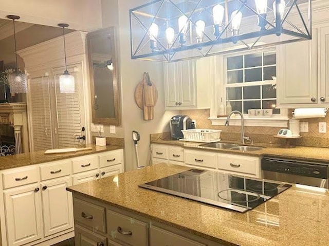 kitchen featuring white cabinetry, pendant lighting, sink, and black electric stovetop