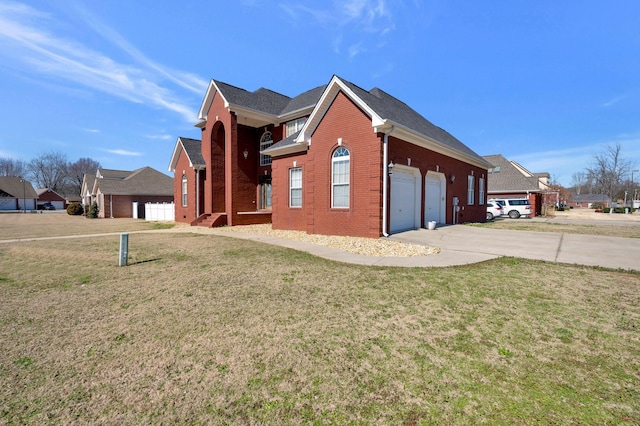 view of home's exterior with driveway, a yard, and brick siding