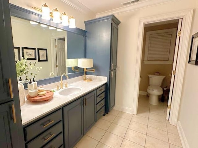 bathroom featuring crown molding, vanity, tile patterned floors, and toilet