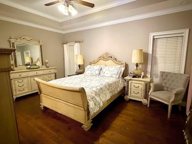 bedroom featuring dark wood-type flooring, ornamental molding, and ceiling fan