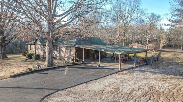 view of parking / parking lot with aphalt driveway