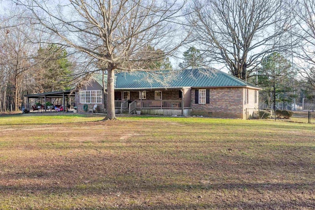 exterior space featuring metal roof, crawl space, a yard, a porch, and brick siding