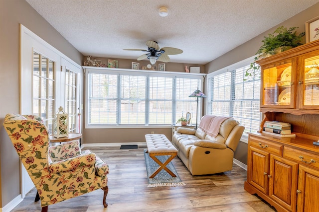 sunroom featuring ceiling fan