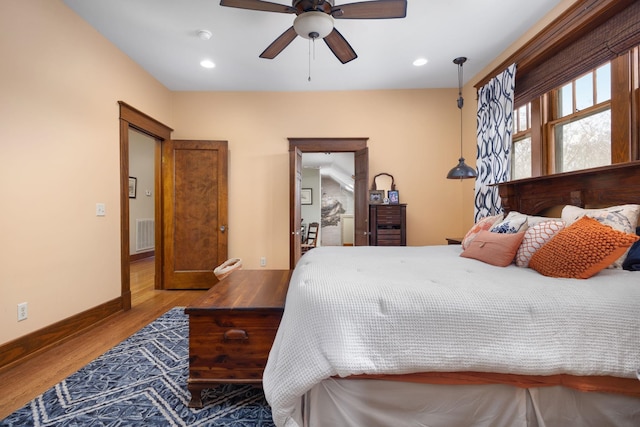 bedroom with recessed lighting, visible vents, ceiling fan, wood finished floors, and baseboards