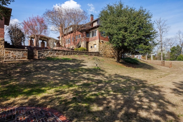 view of yard featuring fence and a pergola