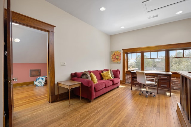 living area with light wood finished floors, attic access, baseboards, visible vents, and recessed lighting