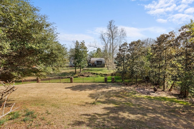 view of yard featuring a rural view and fence