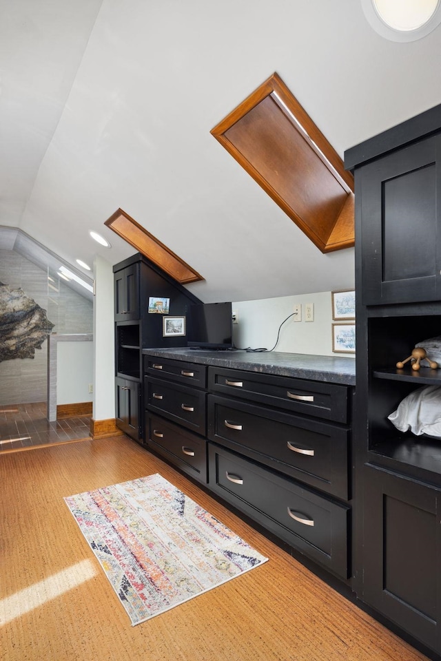 additional living space featuring lofted ceiling and light wood finished floors