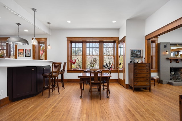 dining area with light wood-type flooring, baseboards, and recessed lighting