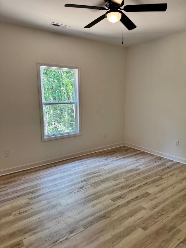  - spare room featuring ceiling fan and wood finished floors