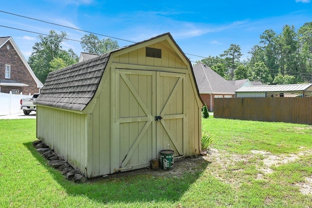 view of outbuilding with a lawn