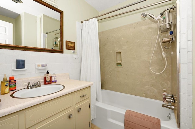 bathroom featuring decorative backsplash, shower / tub combo, vanity, and tile walls