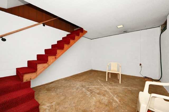 basement featuring a textured ceiling