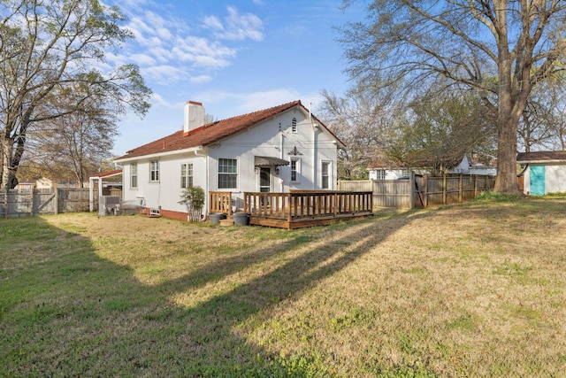  - rear view of house with a deck, a chimney, and a gate