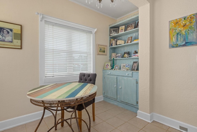  - dining space with crown molding, light tile patterned floors, and baseboards